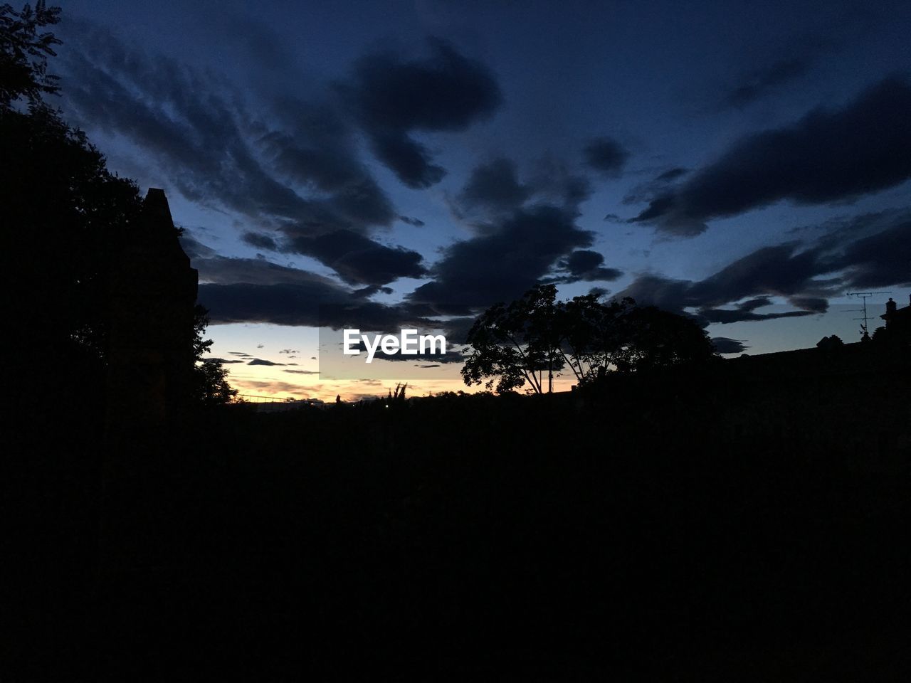 SILHOUETTE LANDSCAPE AGAINST SUNSET SKY