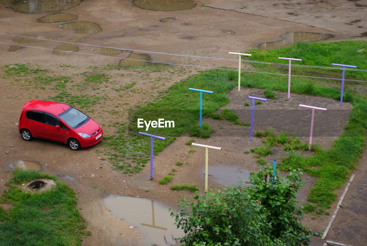 High angle view of red car parked in playground