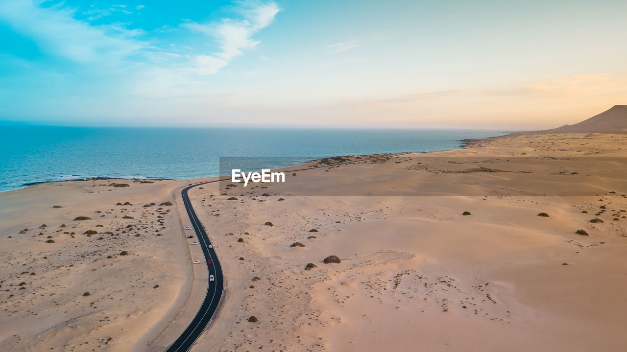 Aerial view of beach against sky during sunset