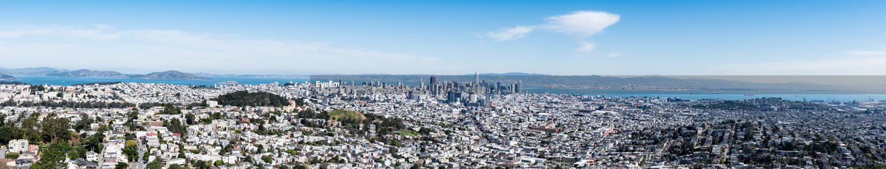 PANORAMIC SHOT OF TOWNSCAPE BY SEA AGAINST SKY