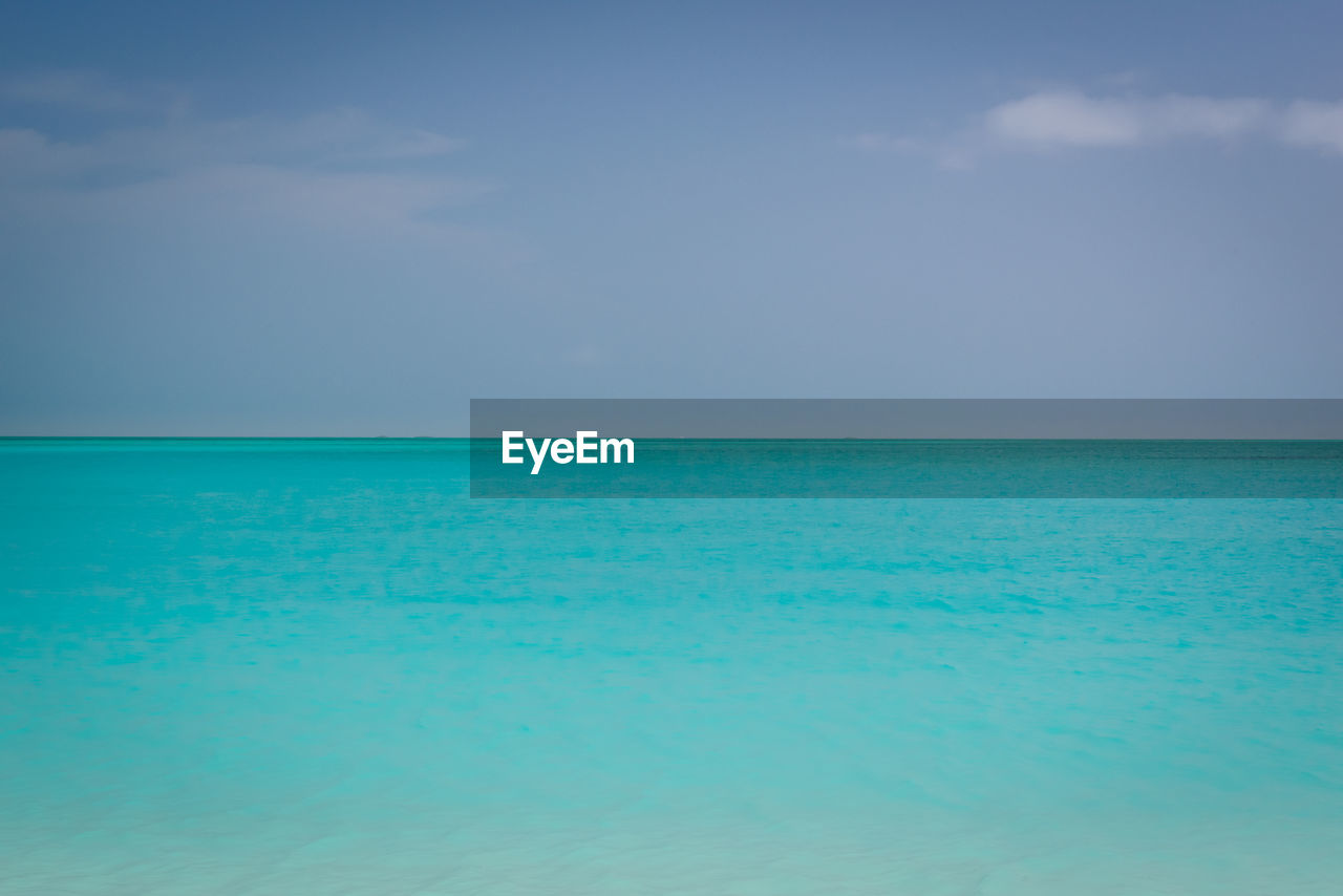 Scenic view of sea against blue sky