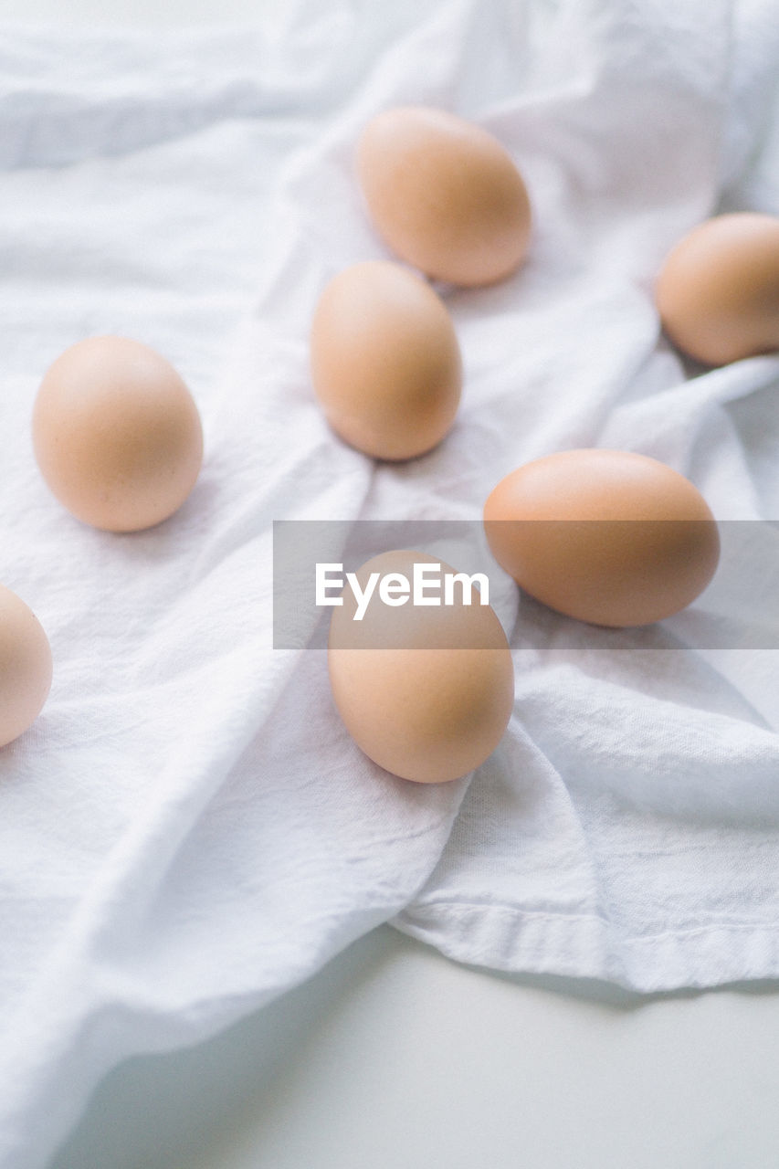 Brown eggs on a white kitchen towel