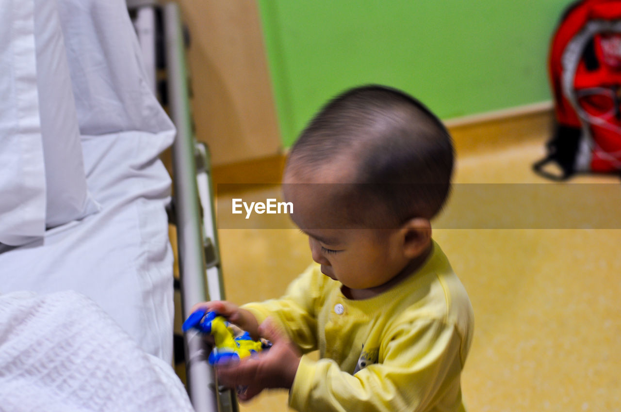 Little boy playing toy in ward