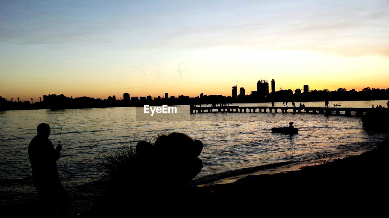 SILHOUETTE OF CITYSCAPE AT SUNSET