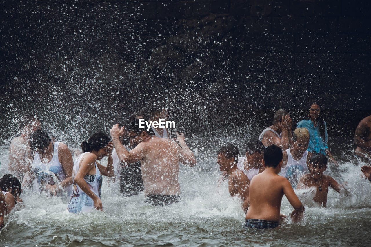 GROUP OF PEOPLE ENJOYING AT WATER