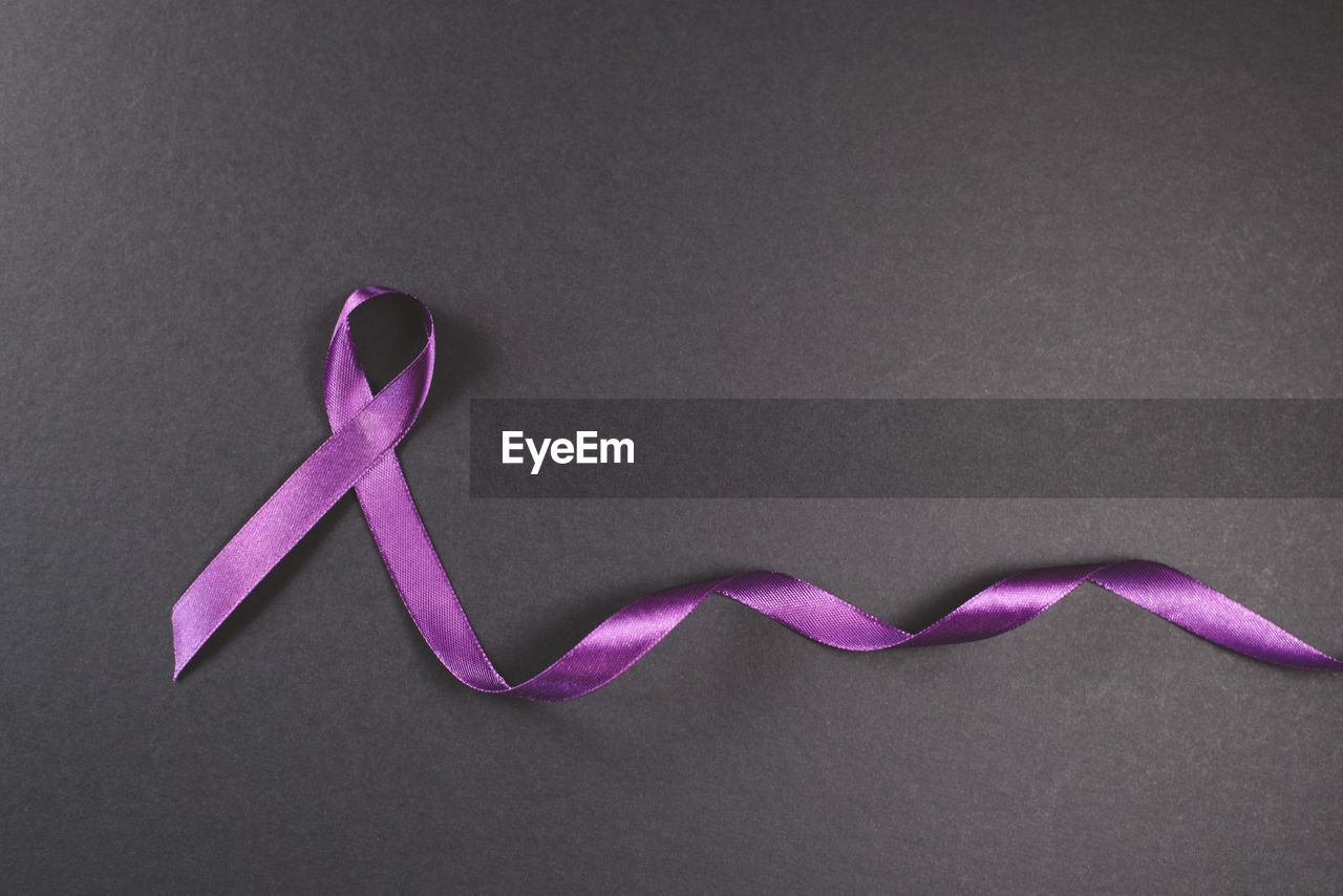 Purple ribbon on black background. symbol of epilepsy awareness