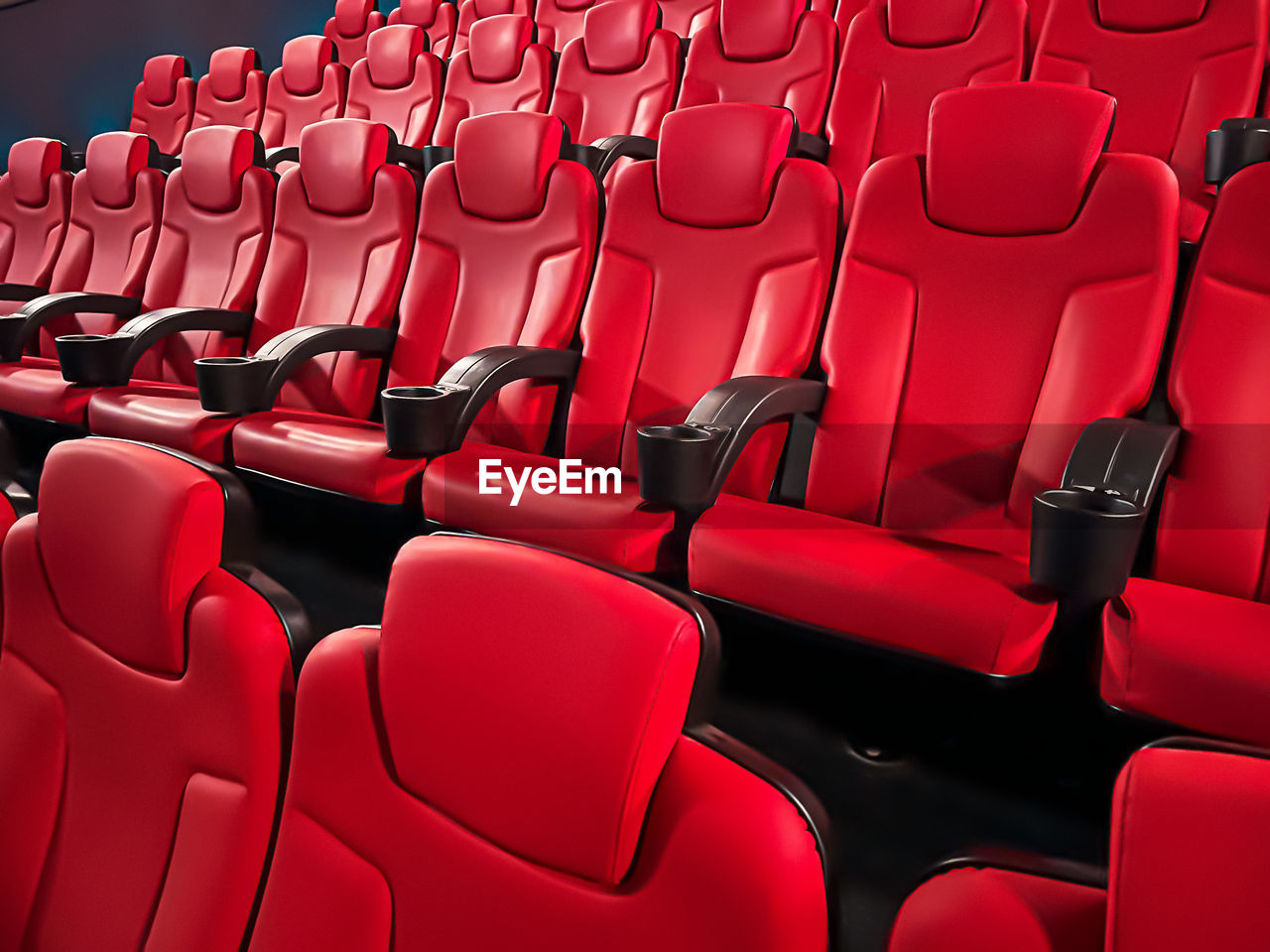 seat, red, in a row, movie theater, arts culture and entertainment, chair, auditorium, empty, stage theater, no people, large group of objects, indoors, repetition, film industry, side by side, absence, movie