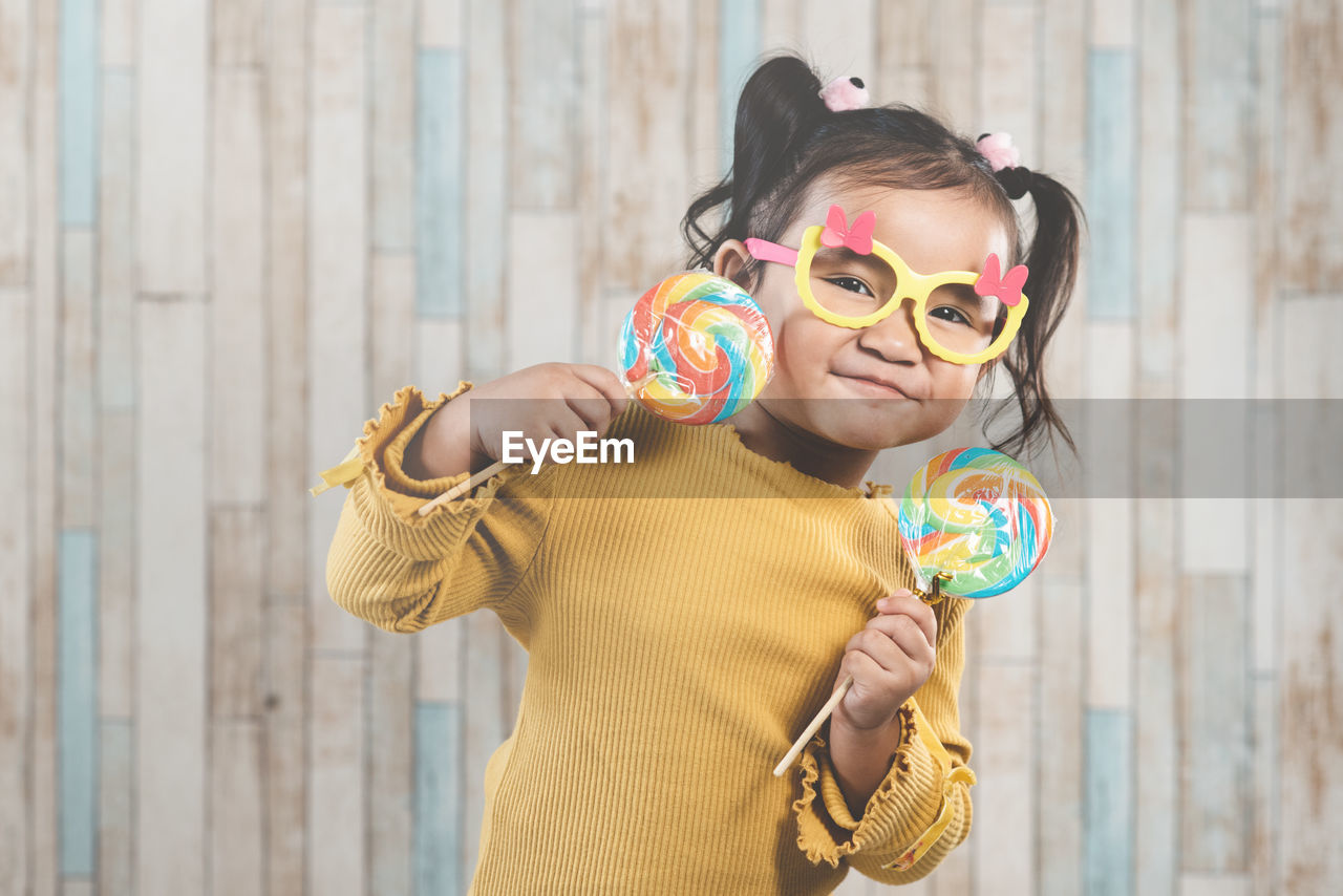 Portrait of girl holding lollipop