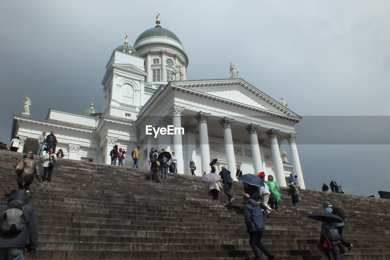 LOW ANGLE VIEW OF PEOPLE AT TEMPLE