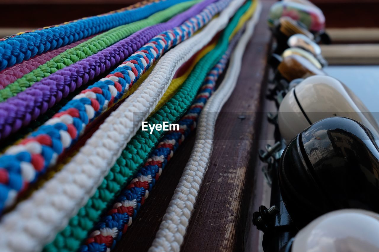 Close-up of colorful ropes by bells in market