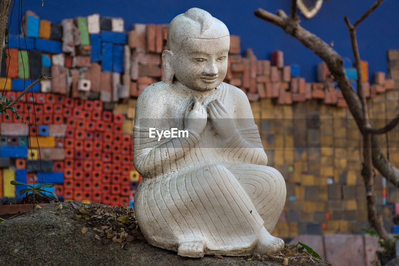 A white ceramic buddha statue in the garden of the tao hong tai ceramics factory in thailand