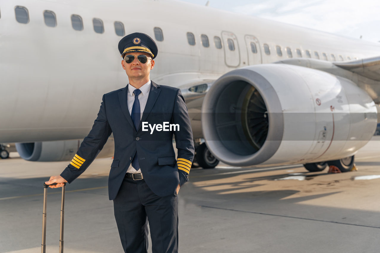 low angle view of man with airplane on airport