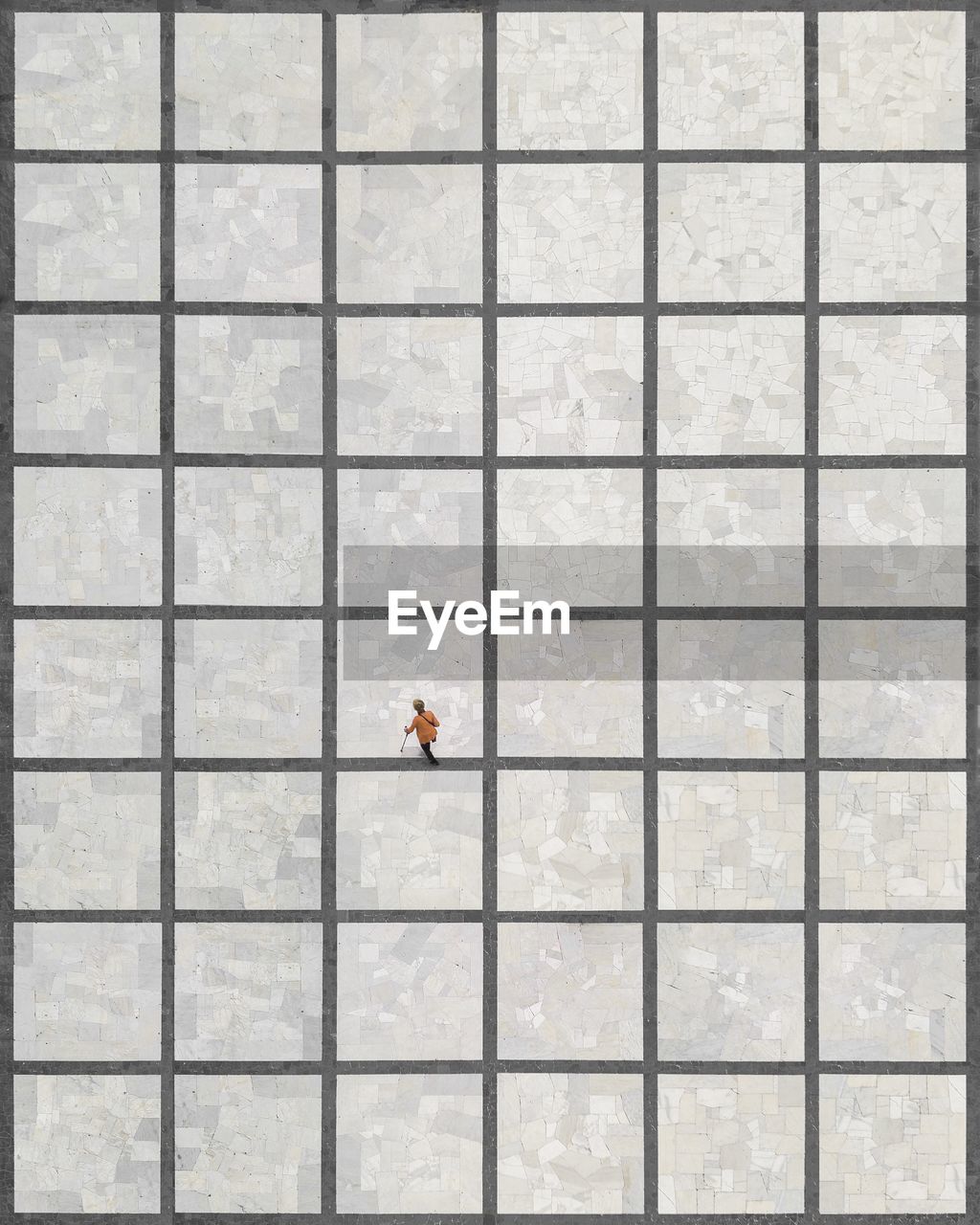 Aerial view of woman walking on tiled floor