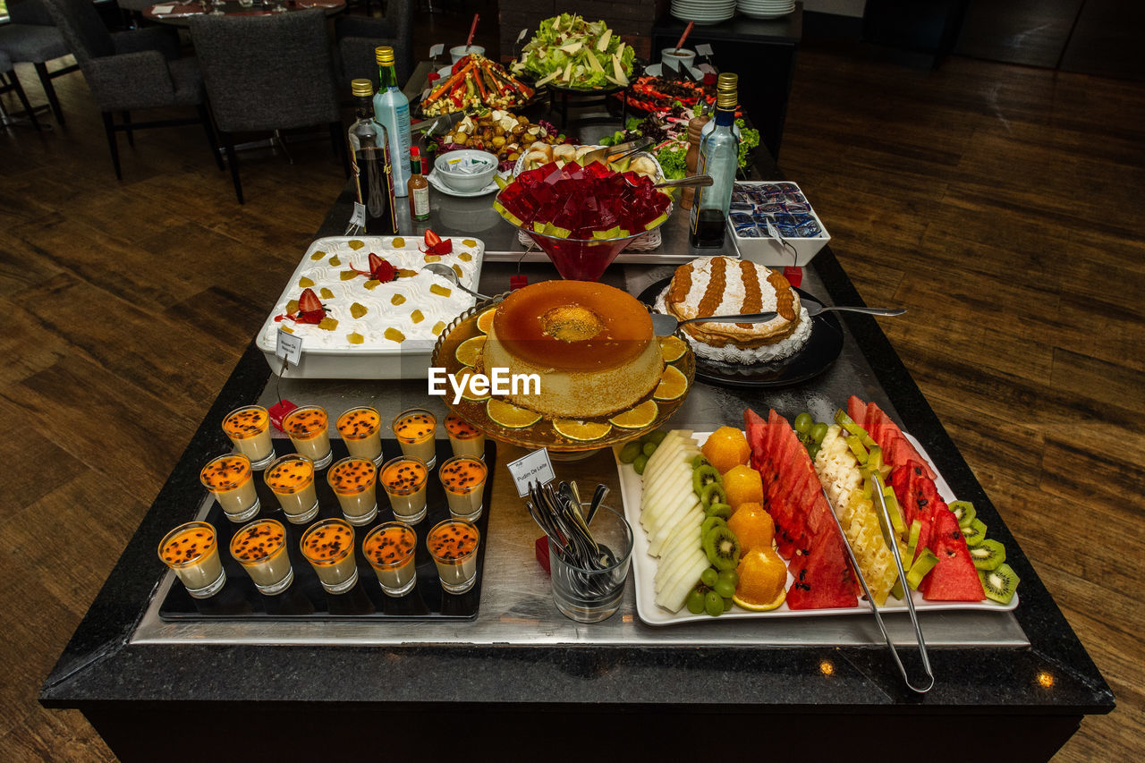food and drink, food, table, healthy eating, meal, freshness, high angle view, fruit, buffet, wellbeing, no people, plate, indoors, vegetable, smörgåsbord, fast food, variation, tray, arrangement, brunch, still life, drink, platter, business, lunch