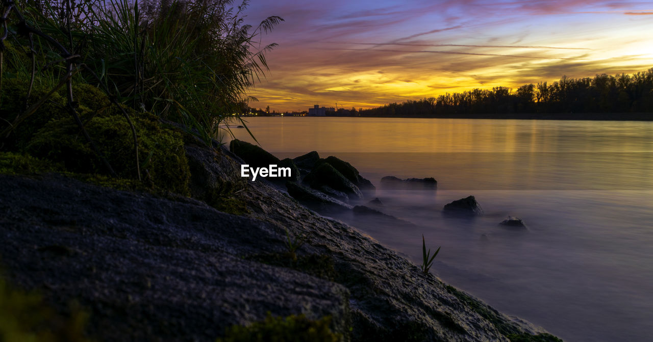 Scenic view of lake at sunset