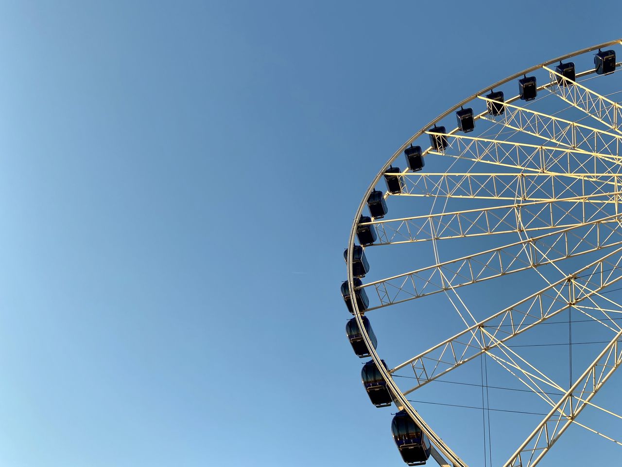 Low angle view of ferris wheel against clear sky