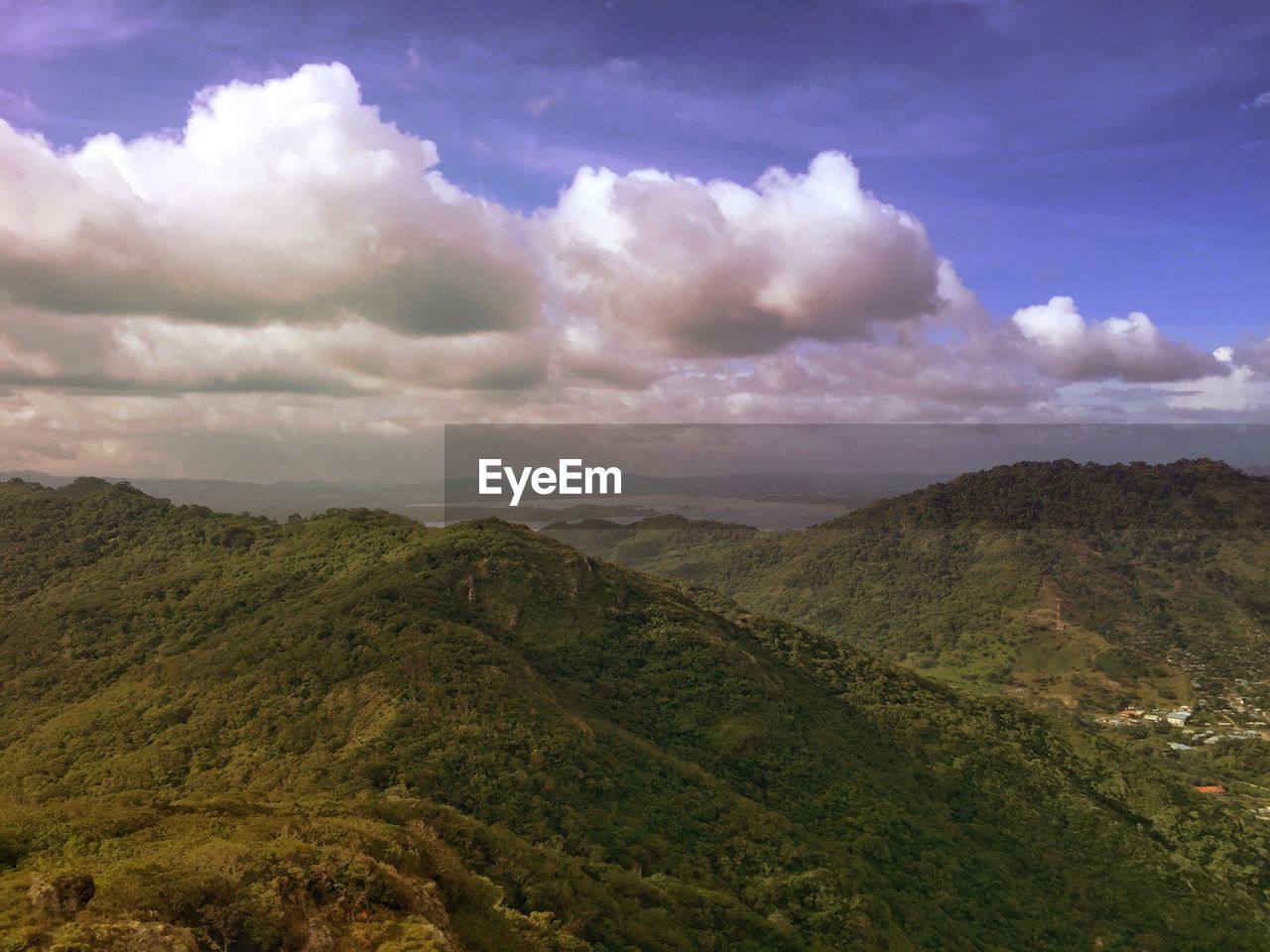 Scenic view of mountains against cloudy sky