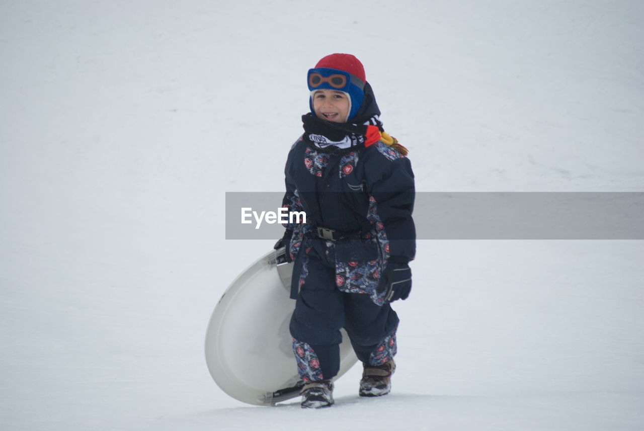 PORTRAIT OF WOMAN STANDING IN WINTER