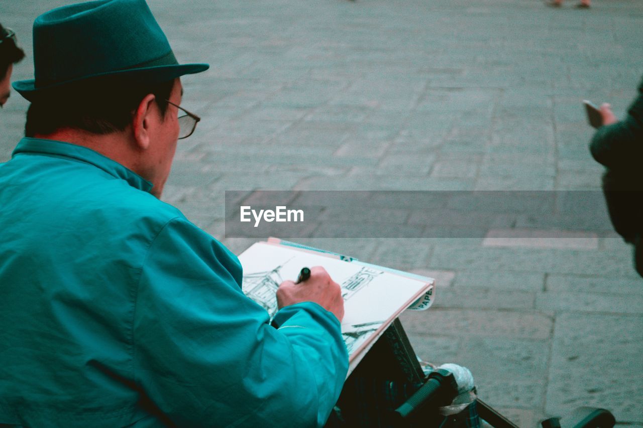 Man writing on book