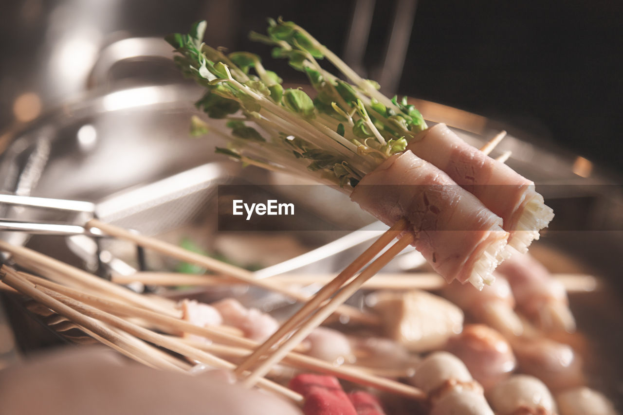 Shabu put in stick style of ham and bean sprouts for grab and bite after boil in the bowl of soup