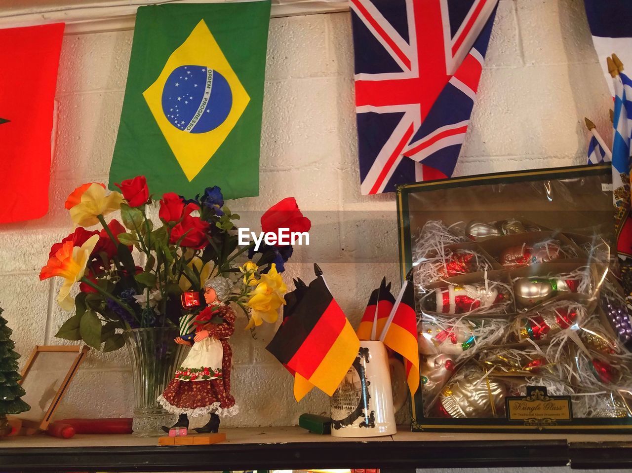 CLOSE-UP OF FLAGS AGAINST RED WALL