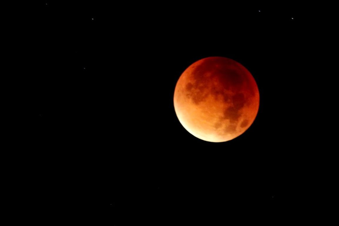 LOW ANGLE VIEW OF MOON IN SKY AT NIGHT