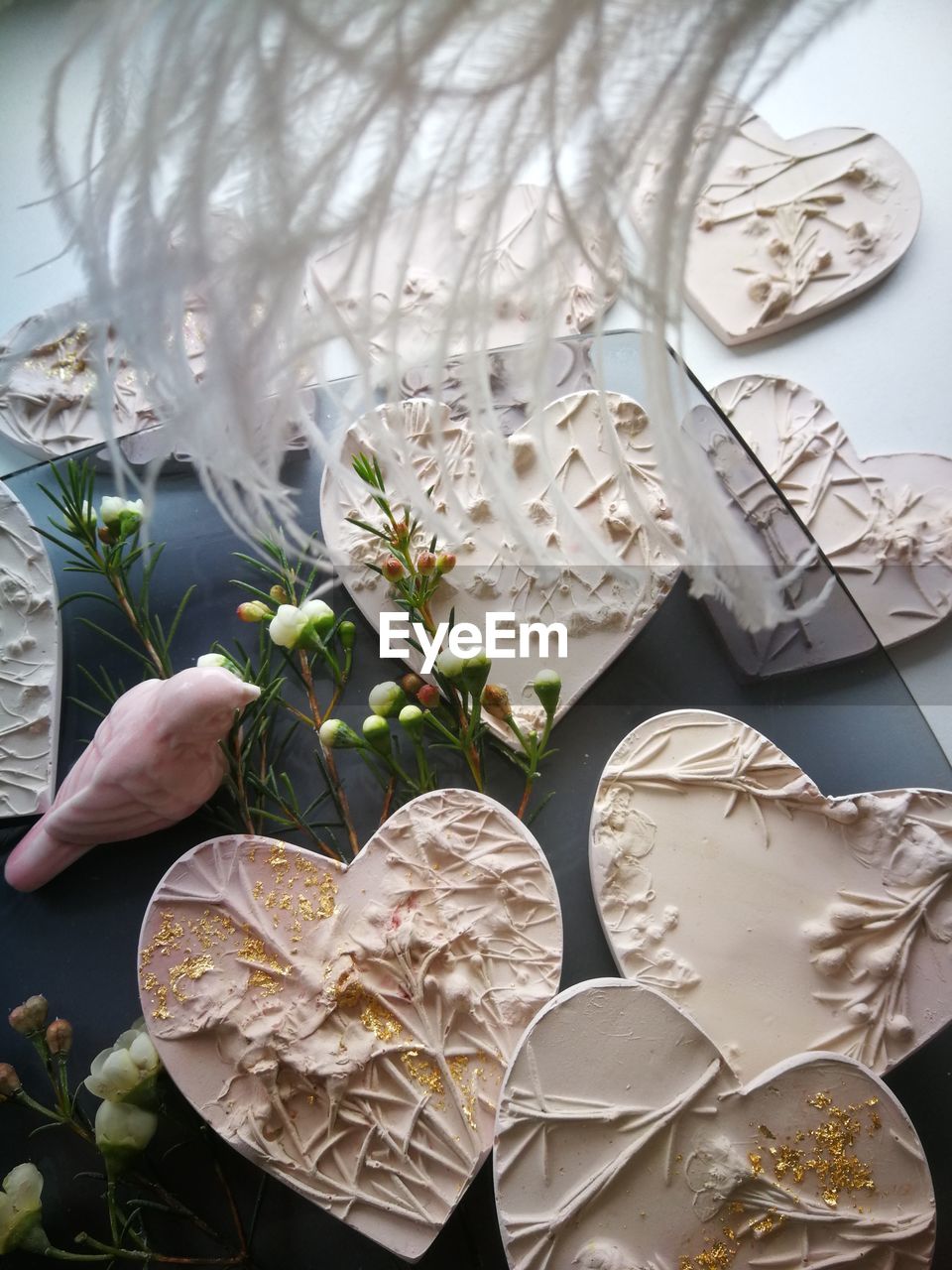 HIGH ANGLE VIEW OF HAND HOLDING WHITE FLOWER