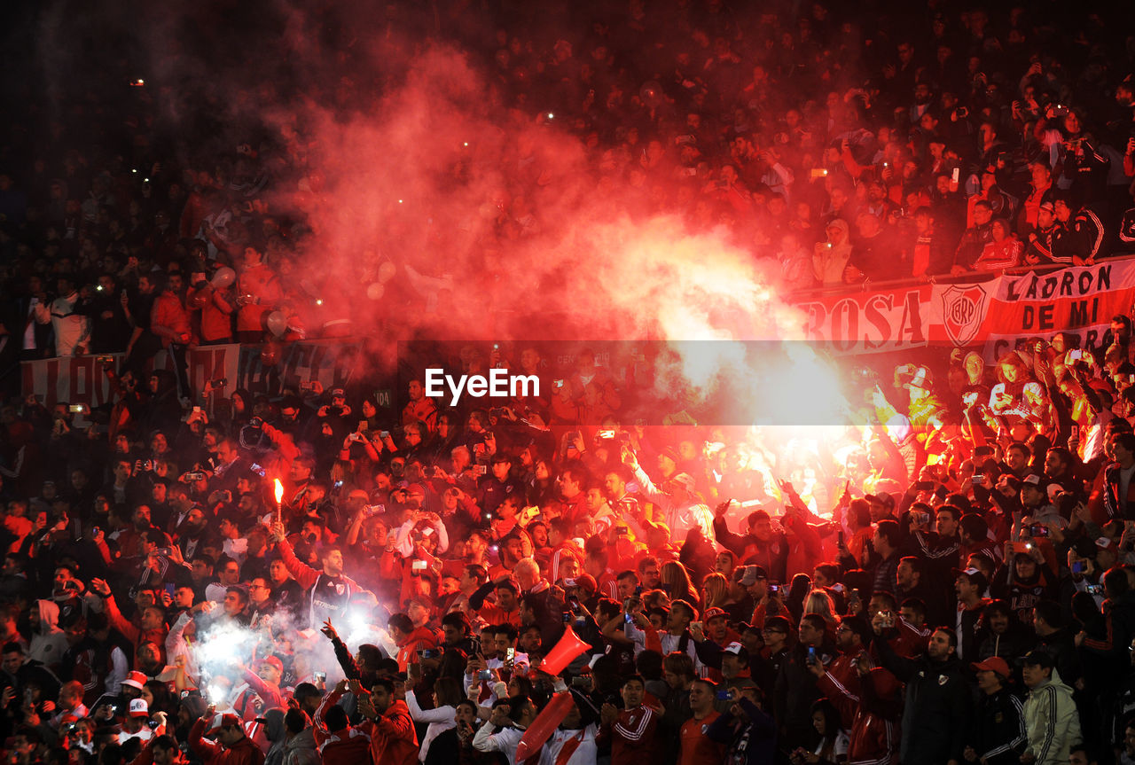 High angle view of people in stadium at night