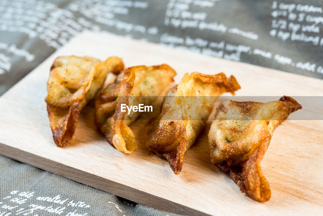Close-up of fried dumplings on cutting board