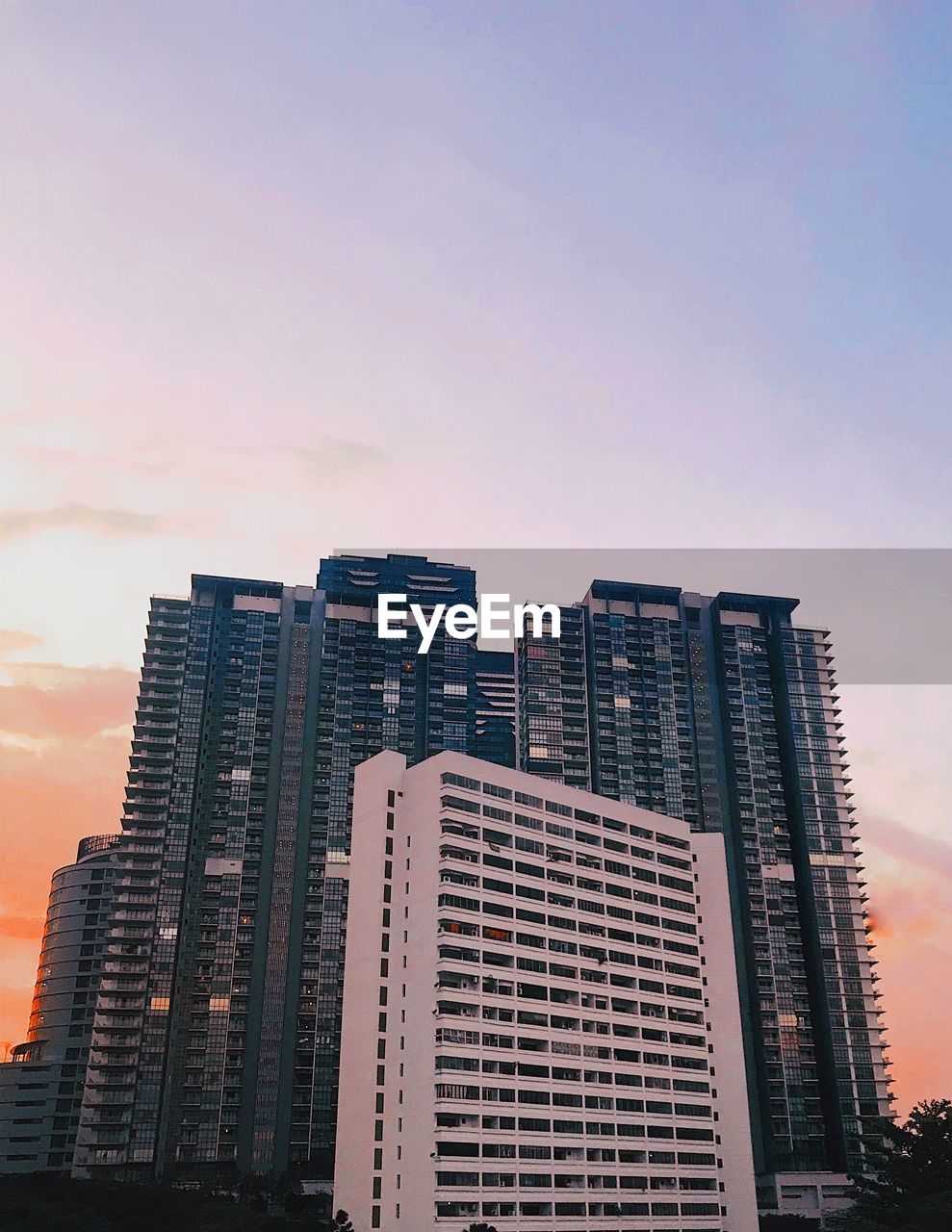 Low angle view of buildings against sky during sunset