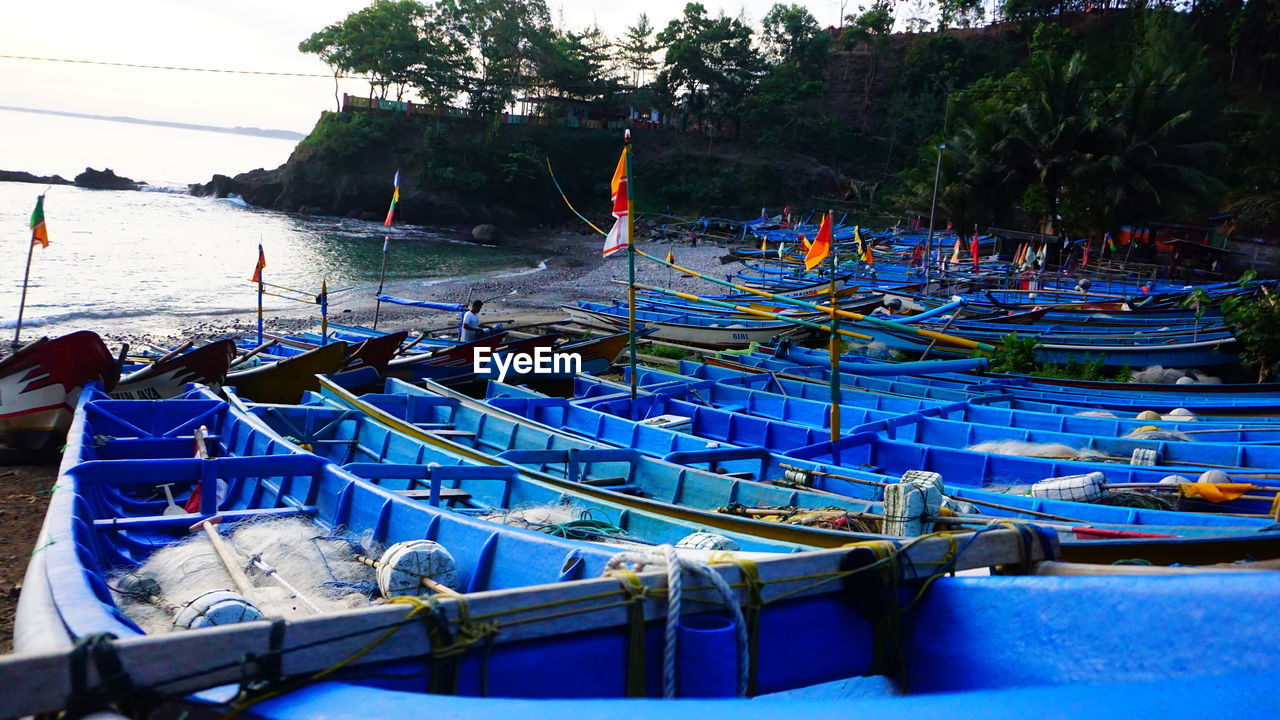 FISHING BOATS MOORED AT HARBOR