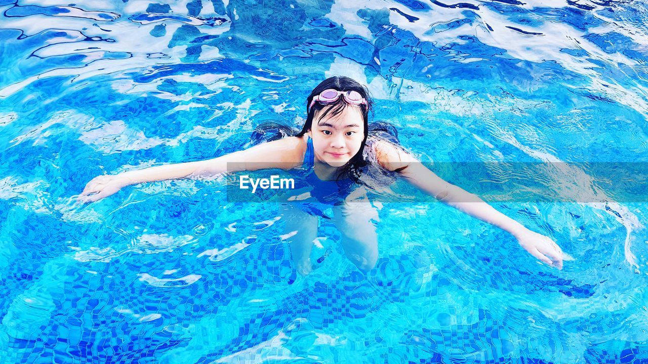 High angle view of woman swimming in pool