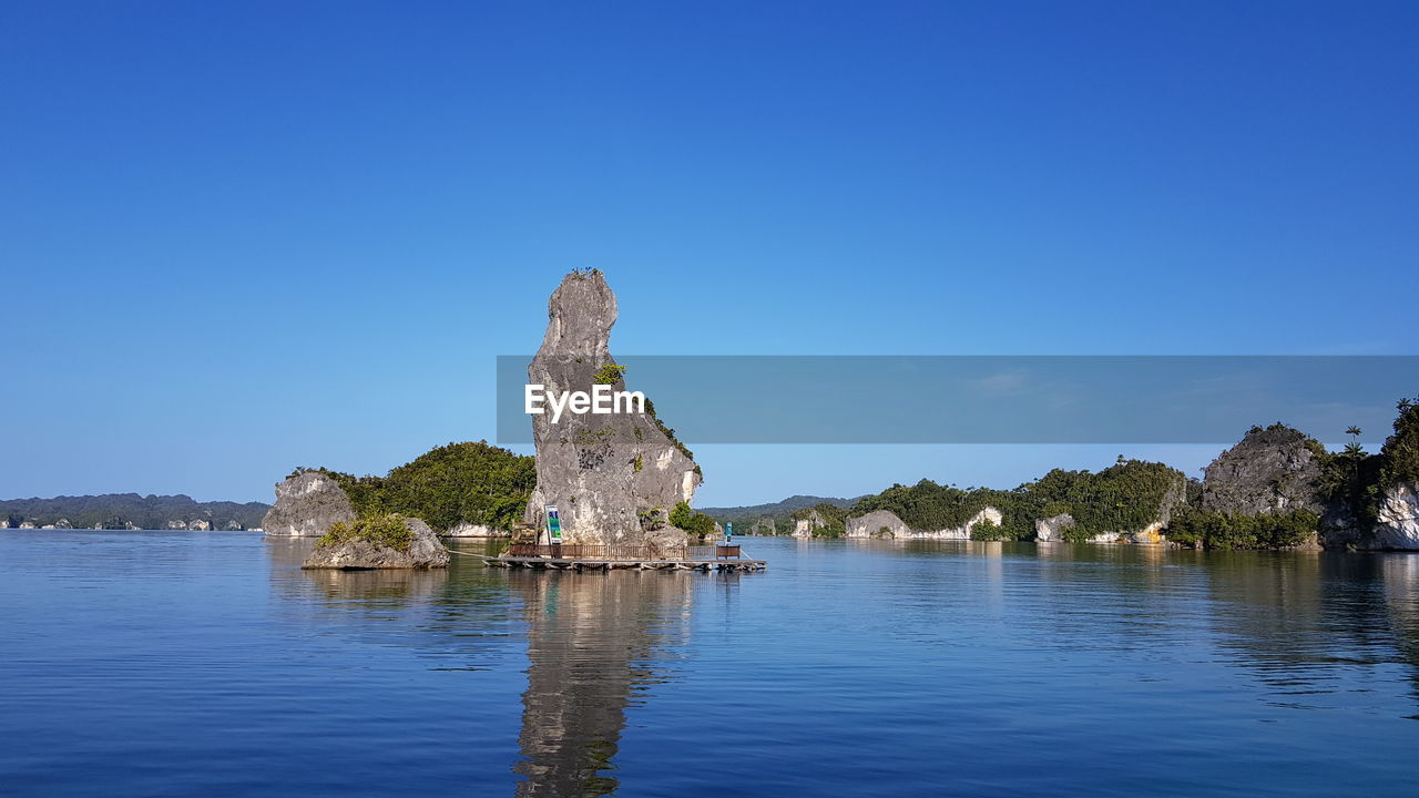 ROCK FORMATIONS AGAINST CLEAR BLUE SKY