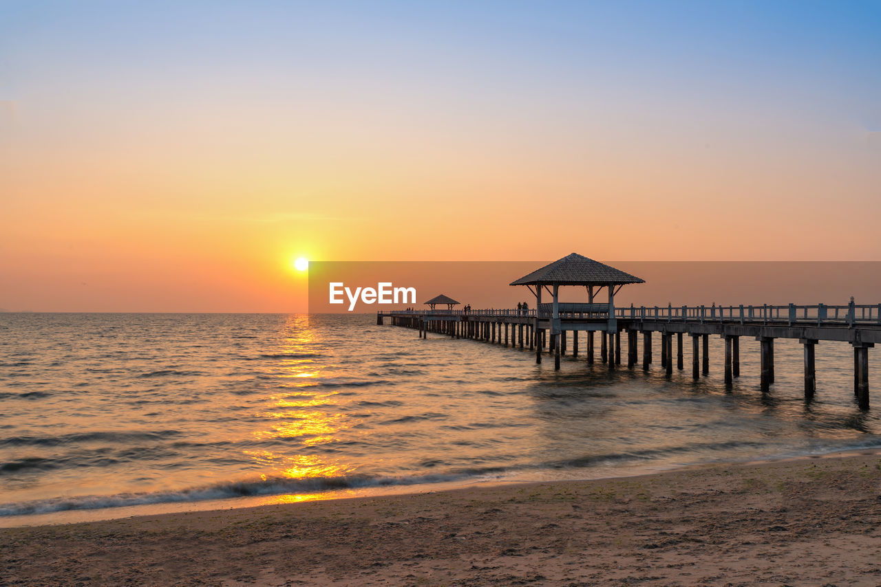 PIER ON SEA AGAINST SKY AT SUNSET