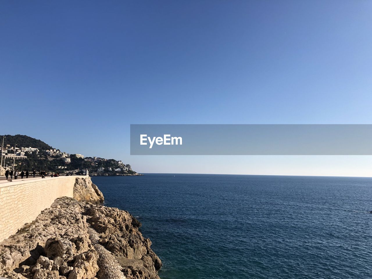 Scenic view of sea against clear blue sky