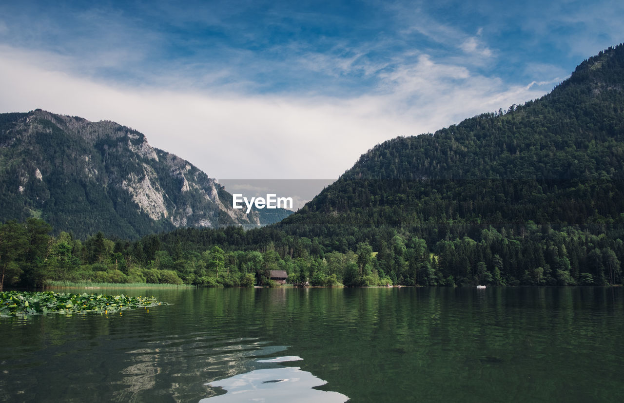 Scenic view of lake and mountains against sky