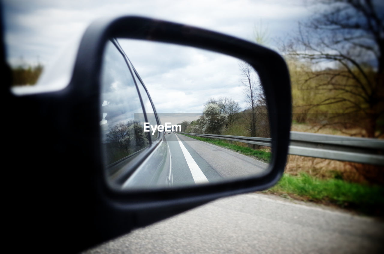 Reflection of road in rear view mirror