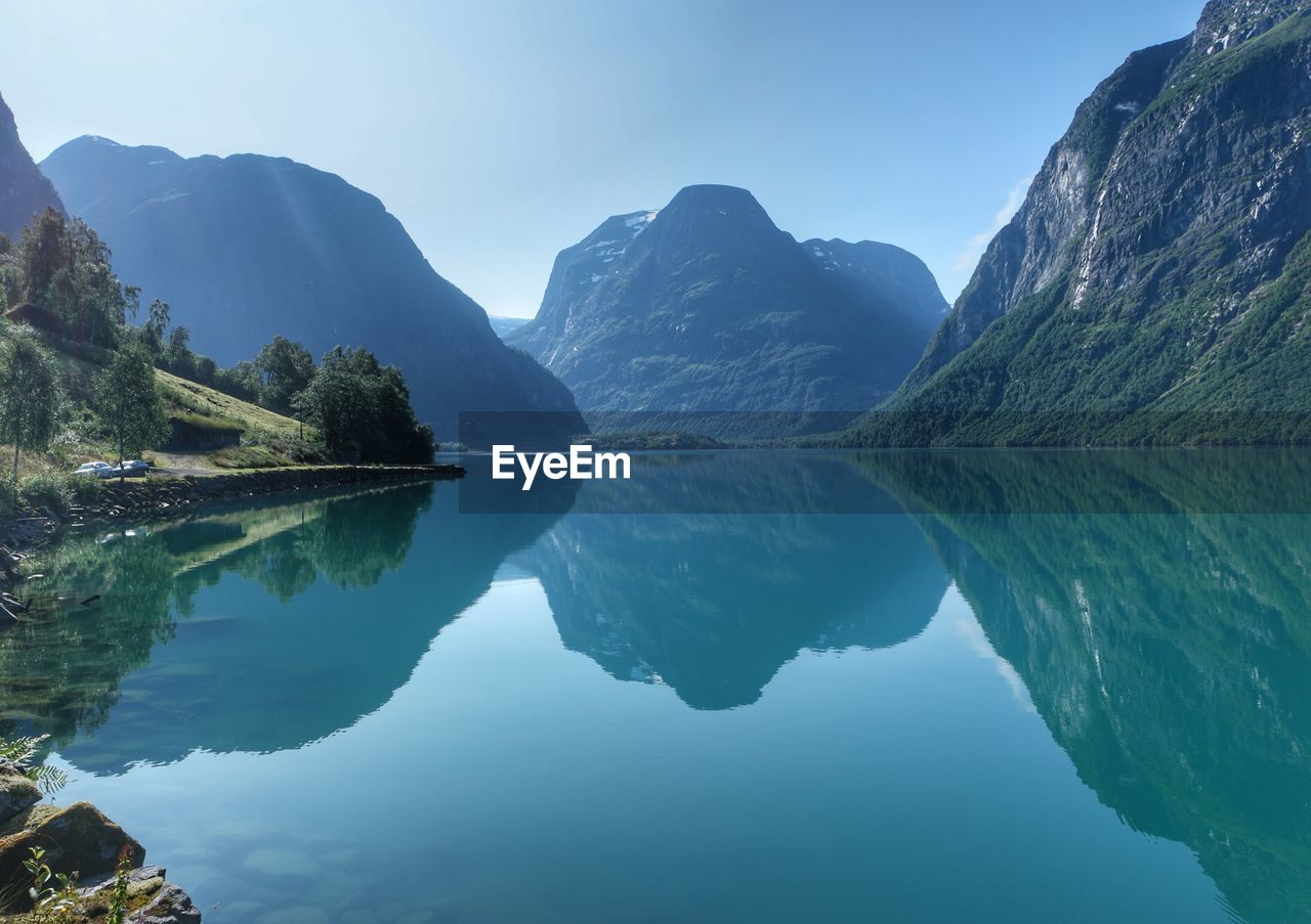 Scenic view of lake and mountains against sky