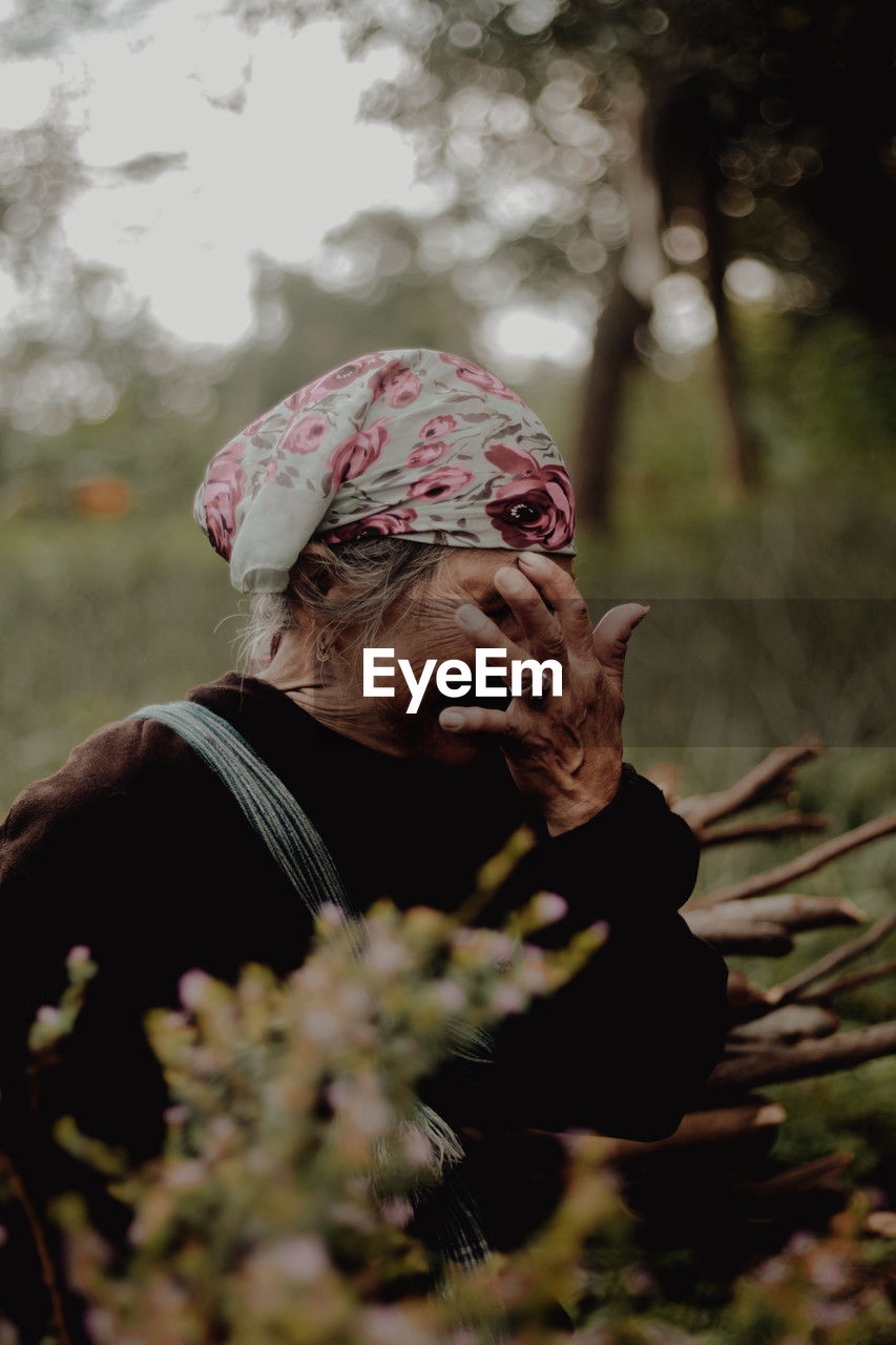 Close-up of old woman looking away