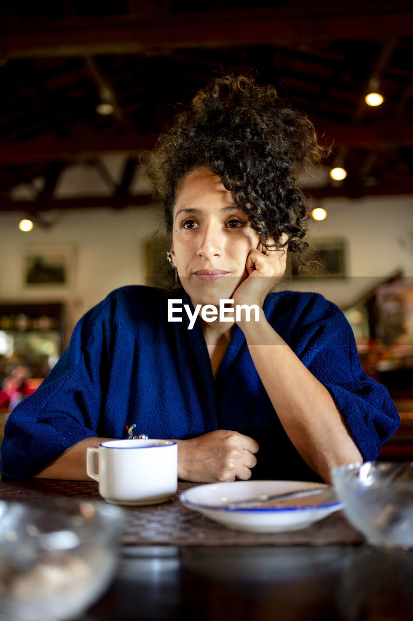 Relaxed woman drinking a cup of coffee,