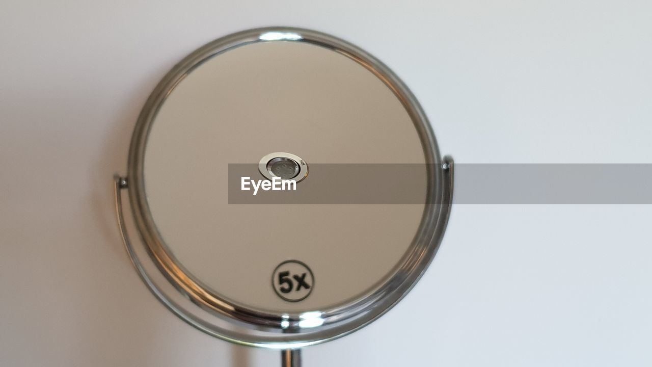 CLOSE-UP OF ELECTRIC FAN AGAINST WHITE BACKGROUND