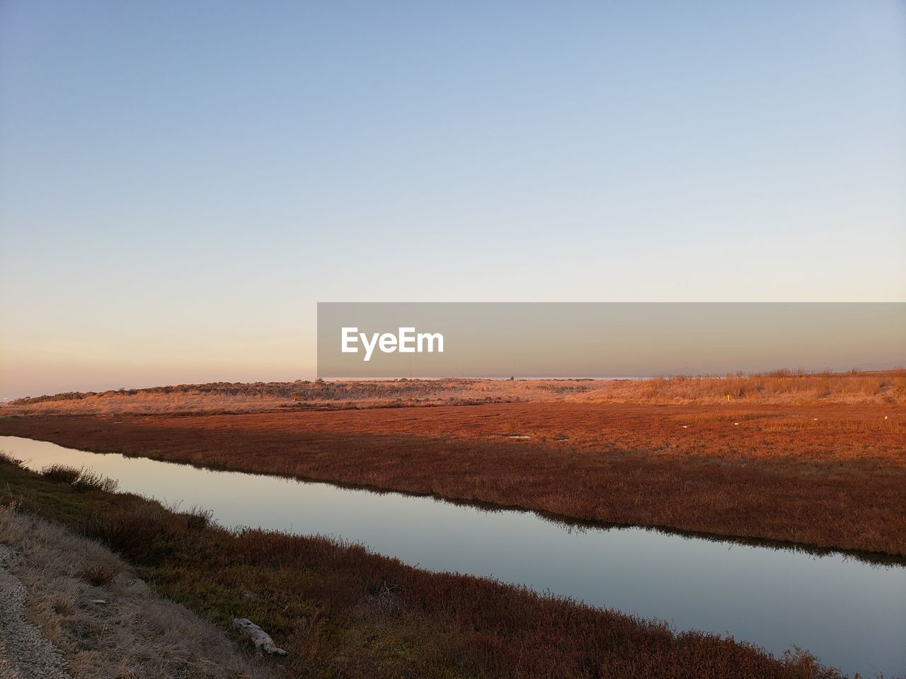 Scenic view of land against clear sky