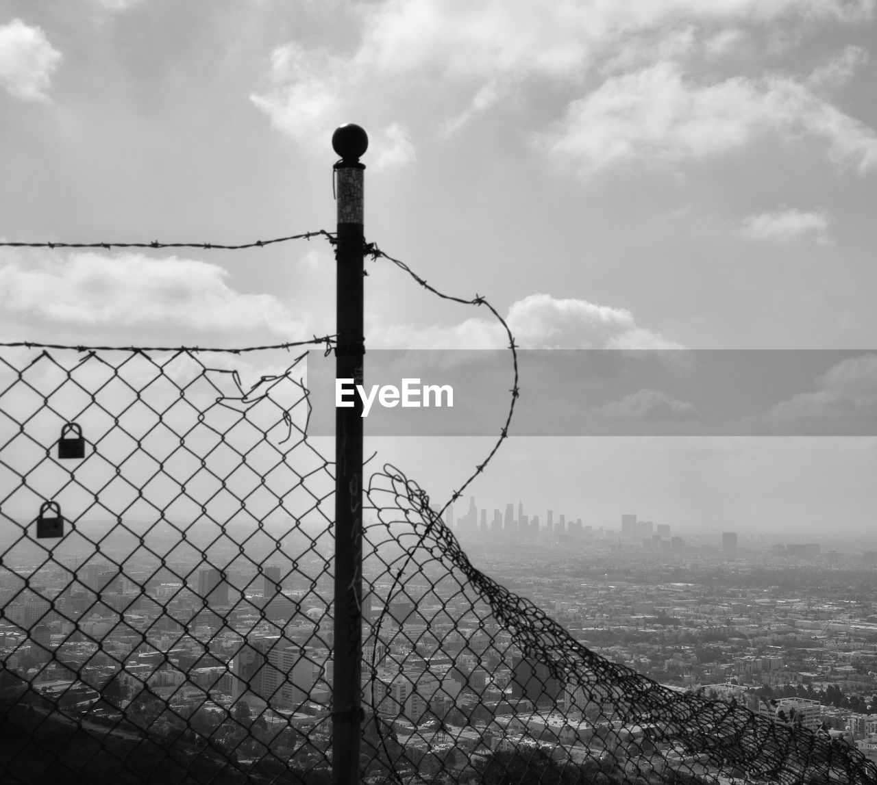 FENCE AGAINST CLOUDY SKY