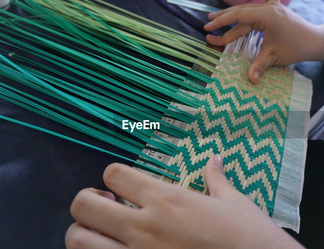 High angle view of person weaving on table