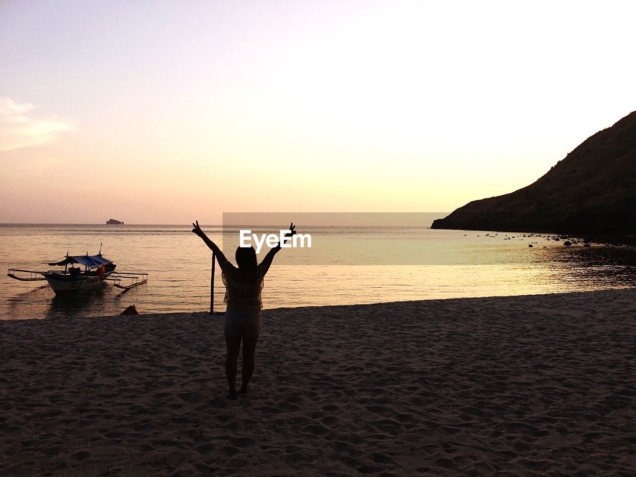 SILHOUETTE MAN ON BEACH AT SUNSET