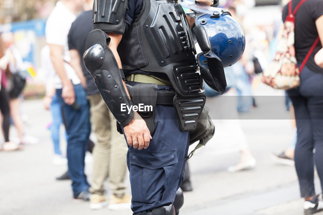 Midsection of man wearing protective workwear