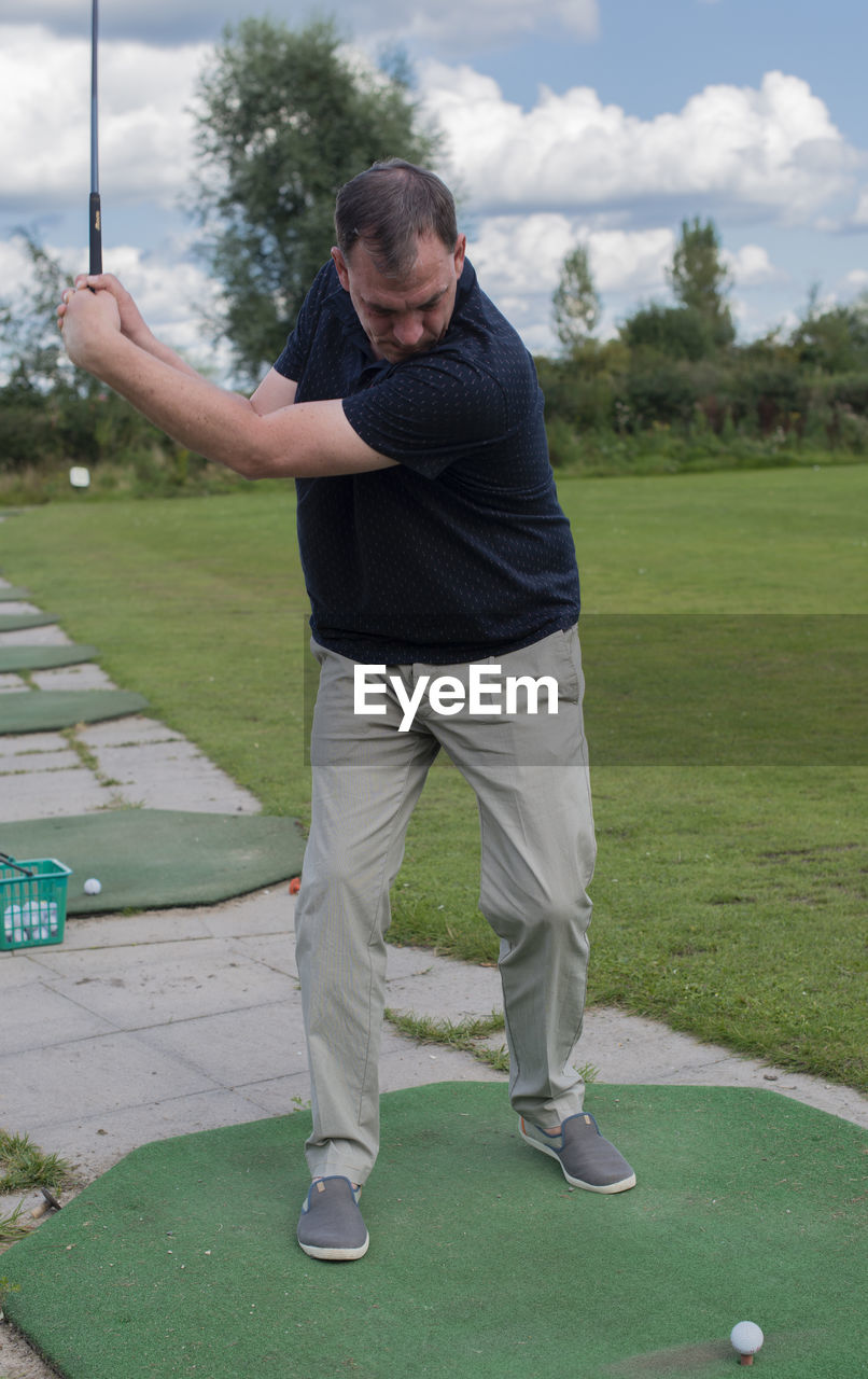 Full length of man playing golf