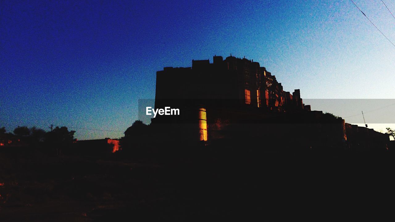 SILHOUETTE OF BUILDINGS AT SUNSET