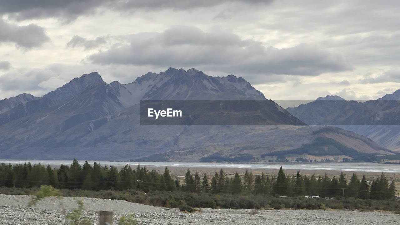 scenic view of snowcapped mountains against cloudy sky