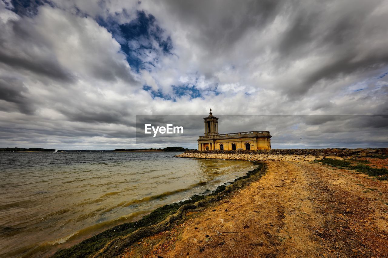 BUILDING ON BEACH AGAINST SKY